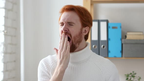 Yawning Tired Young Man with Red Hairs