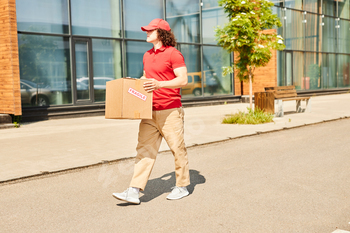 Delivery Person Walking with Express Package Outdoors