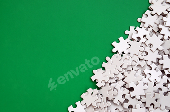 A pile of uncombed elements of a white jigsaw puzzle