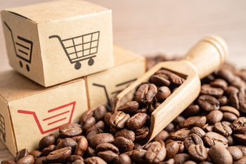 Box with shopping cart logo symbol on coffee beans,