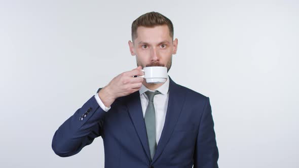 Emotionless Businessman Drinking Coffee