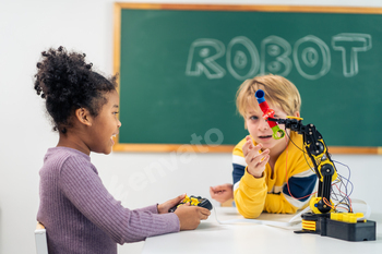 Adorable young student learning in classroom at elementary school.