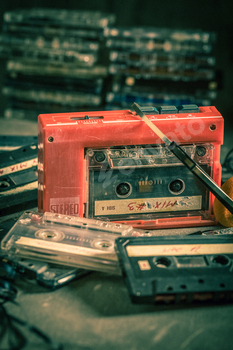 Antique audio cassette with portable player and headphones