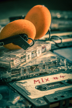 Used stack of audio cassettes and red headphones