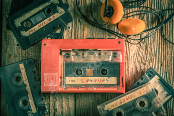 Top down view of audio cassette with player and headphones