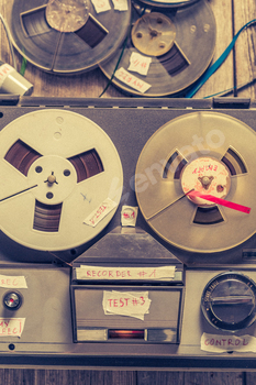 Classic audio tape recorder and a used rolls of tape.