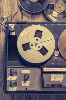 Classic audio tape recorder and roll of tape and microphone.