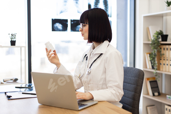 Doctor reviewing medication in modern medical office