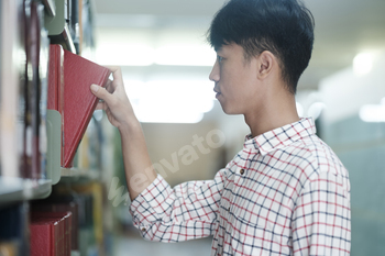 Man Searching for a Book in the Library