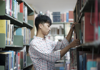 Man Searching for a Book in the Library