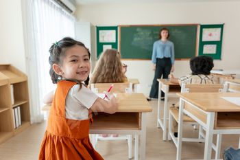 Portrait of Asian schoolgirl learning in classroom at elementary school.