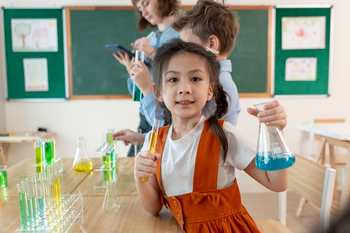 Portrait of Asian kid student learning in classroom at elementary school.