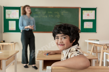 Portrait of Asian schoolboy learning in classroom at elementary school.