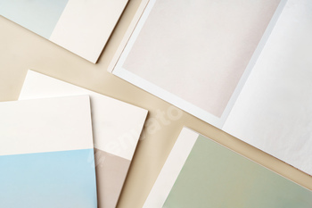 Stack of blank paper on beige background