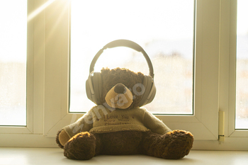 a teddy bear in headphones listen to the audio music radio