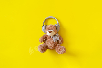 a teddy bear in headphones listen to the audio music radio