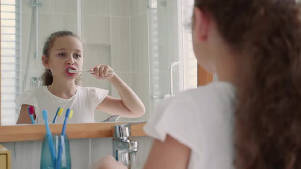 Portrait Happy Cute Young Teenage Girl Brushing Teeth in Bathroom and Smiling