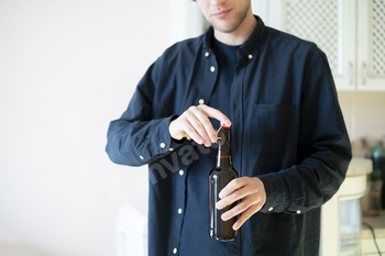 a man open the glass beer bottle on party, bad habit, alcohol addict