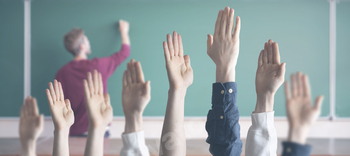 the students at school with raised handsб classroom learning together