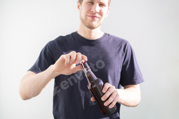 a man open the glass beer bottle on party, bad habit, alcohol addict