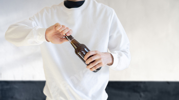 a man open the glass beer bottle on party, bad habit, alcohol addict