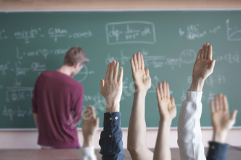 the students at school with raised handsб classroom learning together