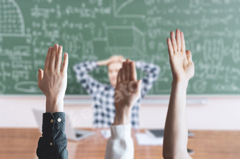 the students at school with raised handsб classroom learning together