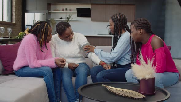 Caring Teenage Daughters Measuring Blood Pressure of Sick Mom