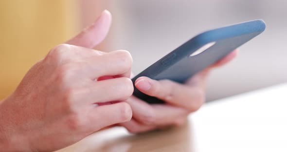 Woman use of mobile phone on the table