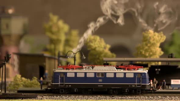 Model Electric Locomotive Waiting for Passengers at Station.