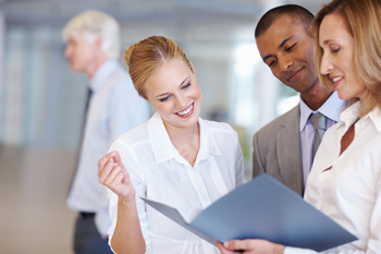 Executive discussing while looking at documents