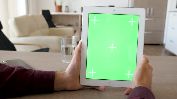 Holding a Digital Tablet PC in Vertical Position with Green Screen Chroma Mock Up