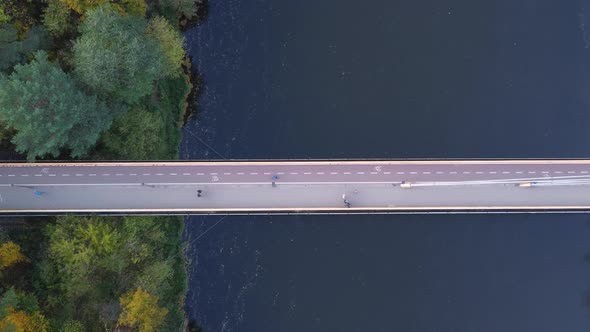 AERIAL Top Down Ascending Shot of a Bridge with Cyclists and Pedestrians in Vilnius, Lithuania durin