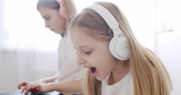 Cute Kids Use Laptops and Headphone for Education Online Study