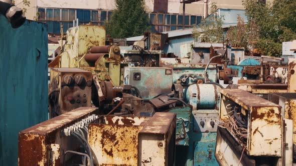 Warehouse of Old Industrial Machines in the Open Air Old Paint Fell Off in Places Exposing the Metal