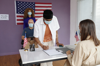 Man In Mask Registrating Before Voting