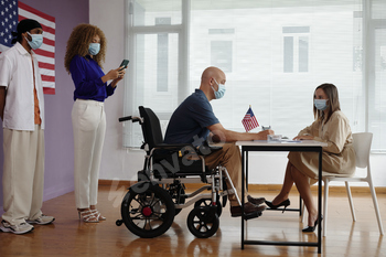 Man With Disability Registrating In Voting Center