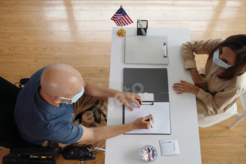 Man In Wheelchair Registrating To Vote