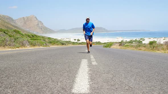 Triathlete man jogging in the countryside road