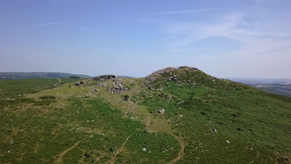 Wide shot aerial tracking forward closer towards Sharps Tor, in the heart of Devon, in the remote mo