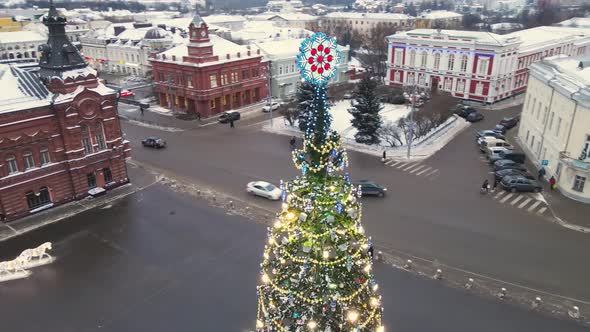 A Beautiful Christmas Tree with Glowing Garlands on a City Street