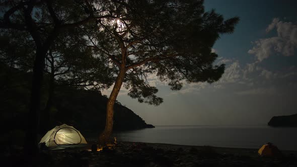 Clouds and the Moon Move Over the Bay and Tent