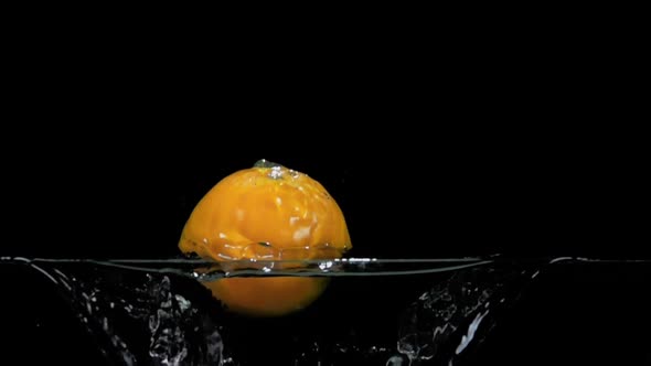 Ripe Juicy Orange is Bouncing From the Water with the Beautiful Splashes