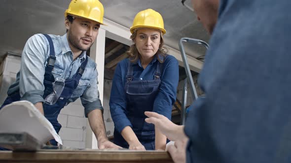 Construction Workers Discussing Documents