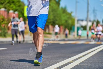 Marathon runners on city road.