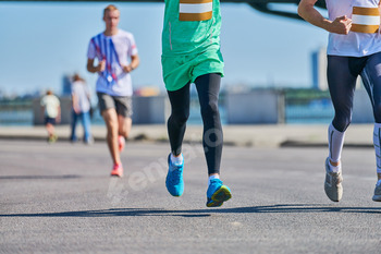 Marathon runners on city road.