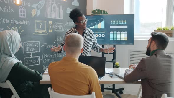 Joyful AfroAmerican Businesswoman Clapping Hands Speaking About Successful Startup Sharing Emotions