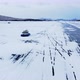 A Hovercraft Rides on the Blue Icy Lake Baikal Covered with White Snow Panoramic Aerial Shot - VideoHive Item for Sale