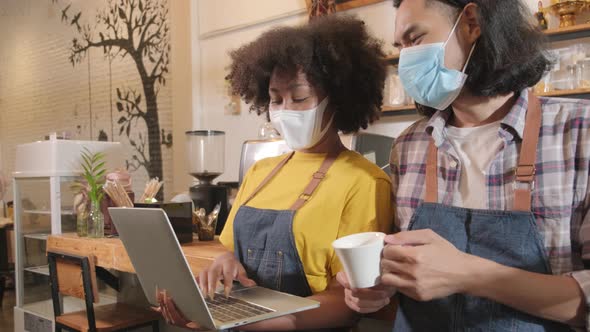 Two barista partners wait for customers order in new normal lifestyle service.