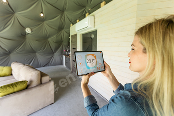 Young woman using application smart home